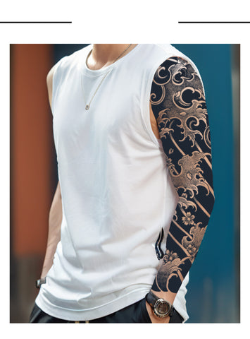 Person wearing a white sleeveless shirt with a detailed tattoo on one arm.