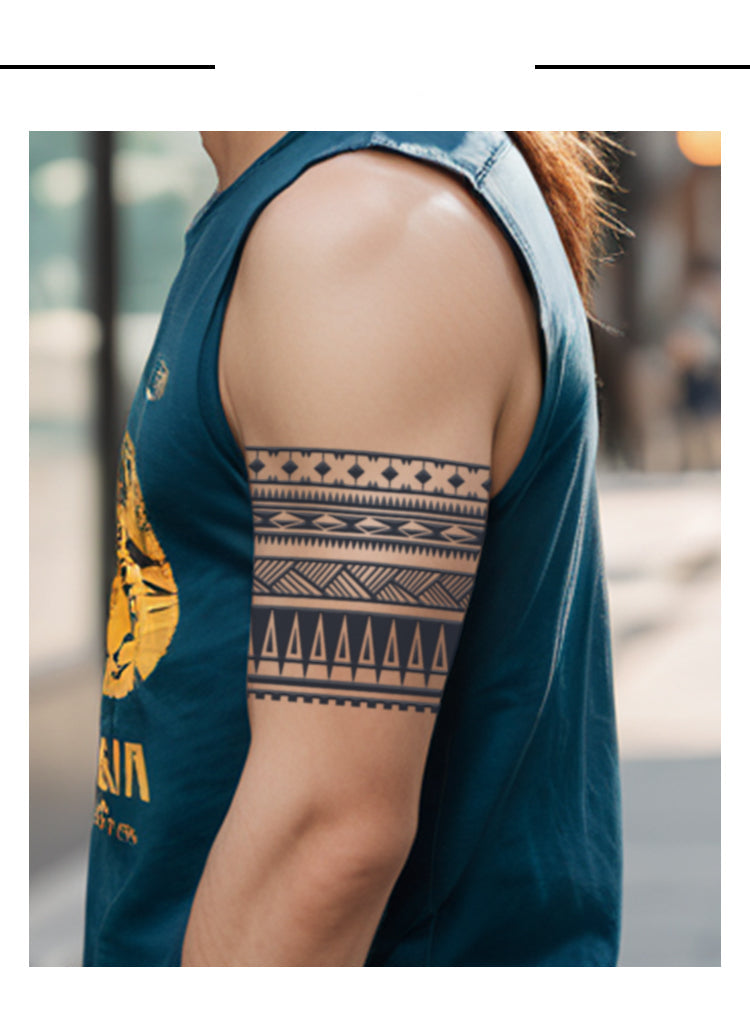 Person wearing a sleeveless denim shirt with a geometric arm tattoo.