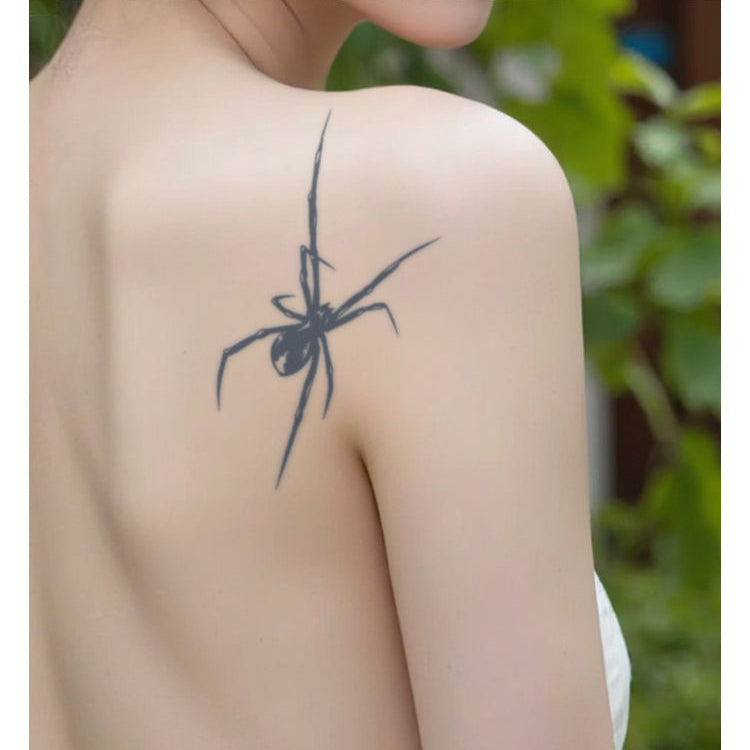 Spider tattoo on a person's shoulder with a blurred background