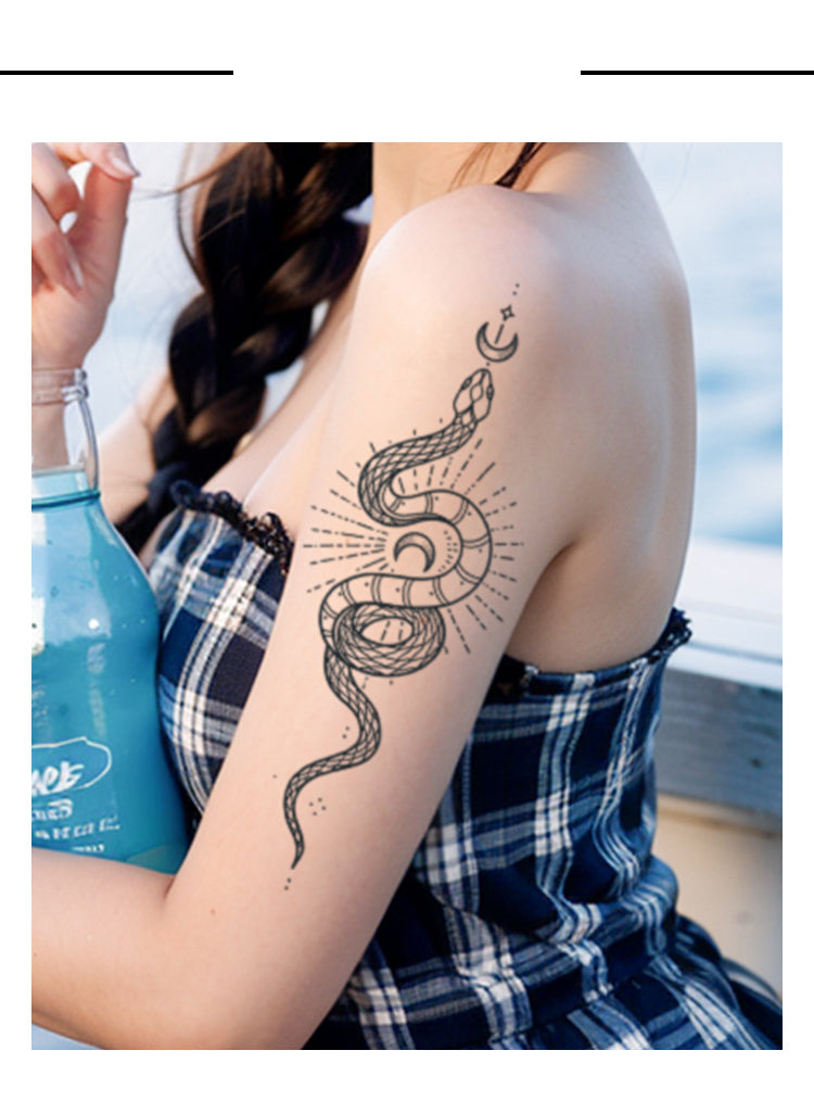 Person with snake tattoo on arm holding a blue bottle.